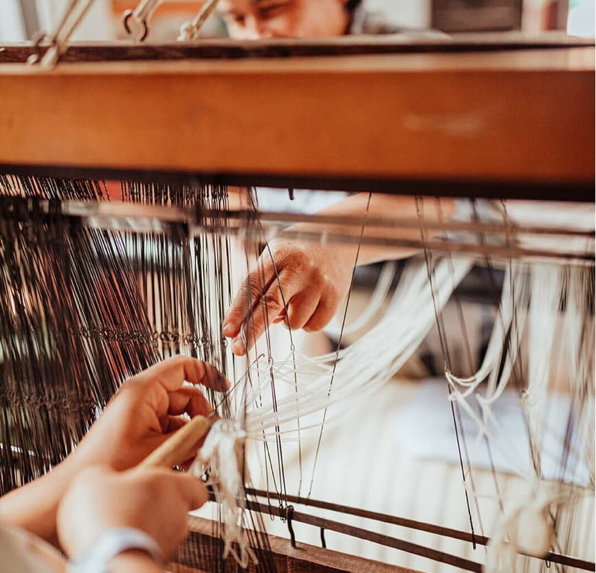 Artisan weaving on loom women owned business sustainable corporate gifting social impactArtisan weaving on loom women owned business sustainable corporate gifting social impact