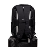 Lightweight Water Resistant Backpack 12L in black, back, showing straps and attached to a carry-on luggage handle