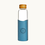 Reusable glass water bottle with blue silicone sleeve and bamboo lid, personalised corporate gift for conferences