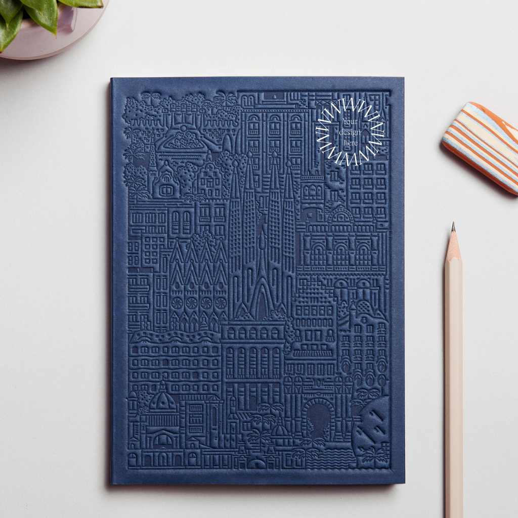 Debossed Barcelona notebook in blue. Sustainable branded merchandise from women-owned brands.