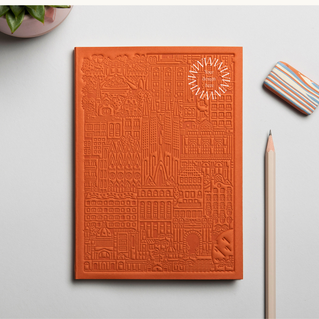 Debossed Barcelona notebook in orange. Sustainable event merchandise from women-owned brands.