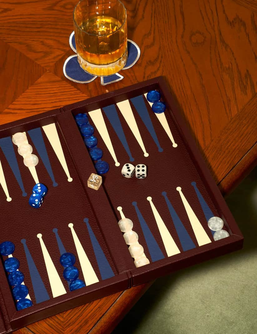 Lifestyle picture of burgundy leather booklet backgammon set personalised corporate gift from women owned businesses for client events and executive gifting