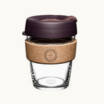 12oz reusable glass cup with a natural cork band, burgundy lid, showing logo placement on the cork band