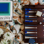Classic leather backgammon set in burgundy in use, a premium corporate gift built around social connectivity and shared moments.