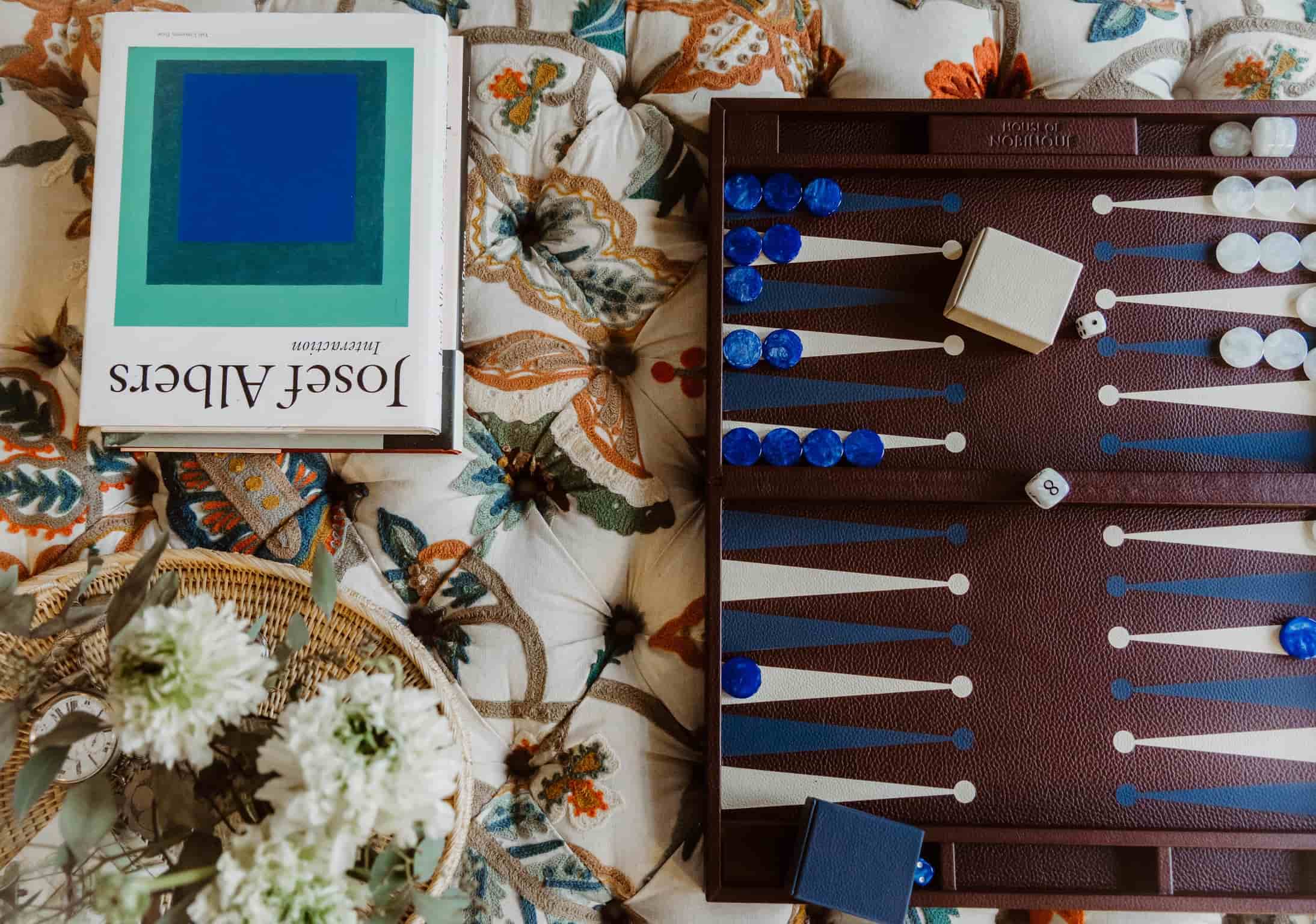 Classic leather backgammon set in burgundy in use, a premium corporate gift built around social connectivity and shared moments.