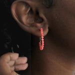 Handcrafted coral beaded hoop earrings, a unique corporate gift for women