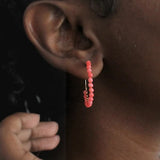 Handcrafted coral beaded hoop earrings, a unique corporate gift for women