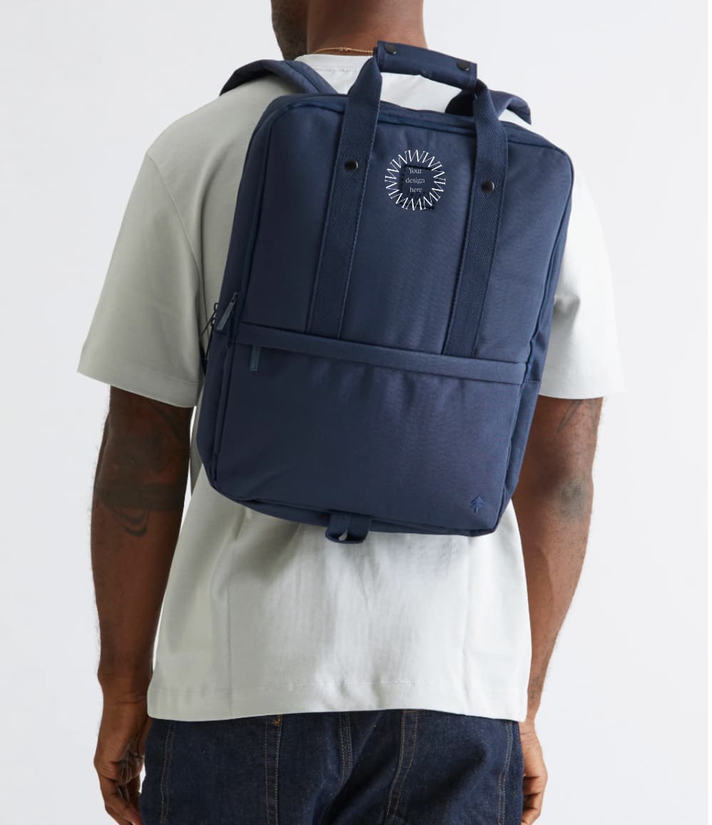 Daily 15" Backpack in blue, worn, showing logo placement