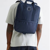 Daily 15" Backpack in blue, worn, showing logo placement