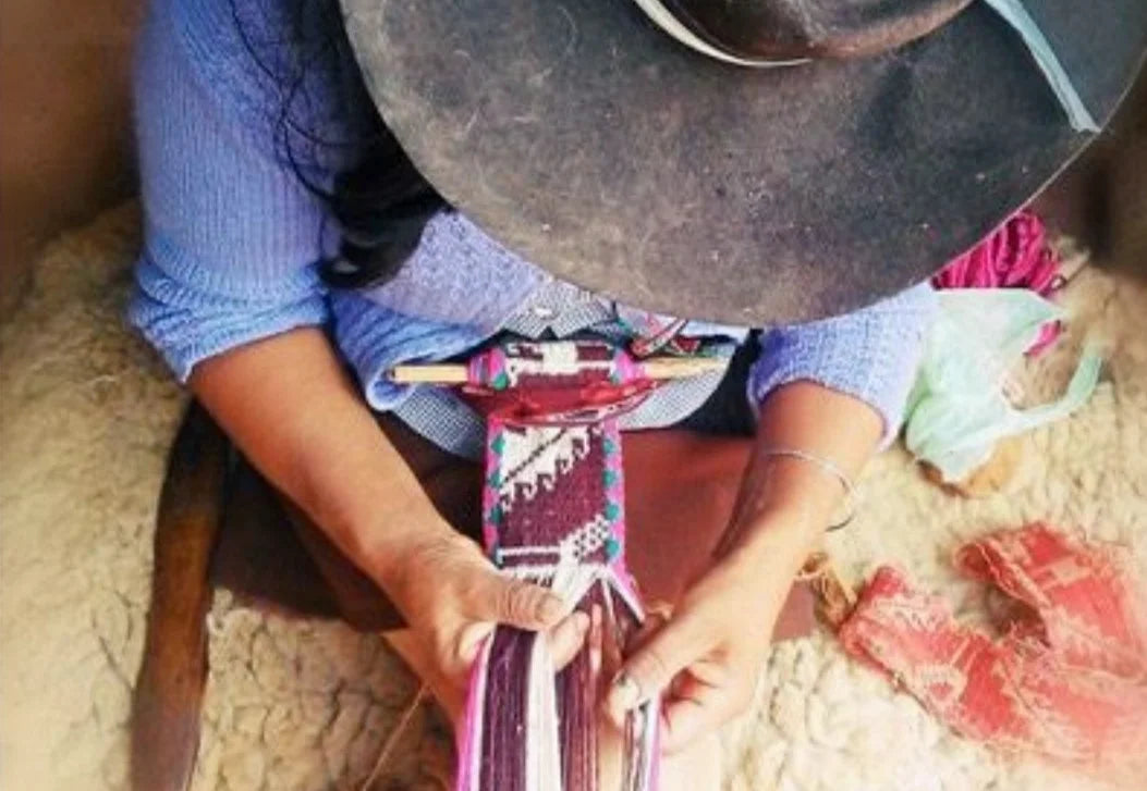 Female artisan hand weaving traditional textiles, sustainable corporate gifts from women-owned businesses