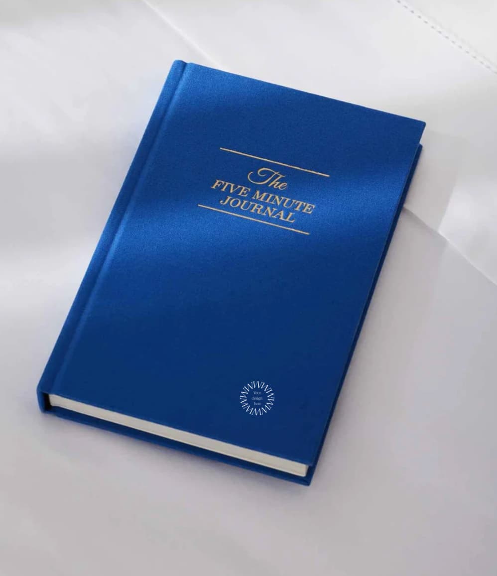 The Five Minute Journal, front cover in blue, showing logo placement