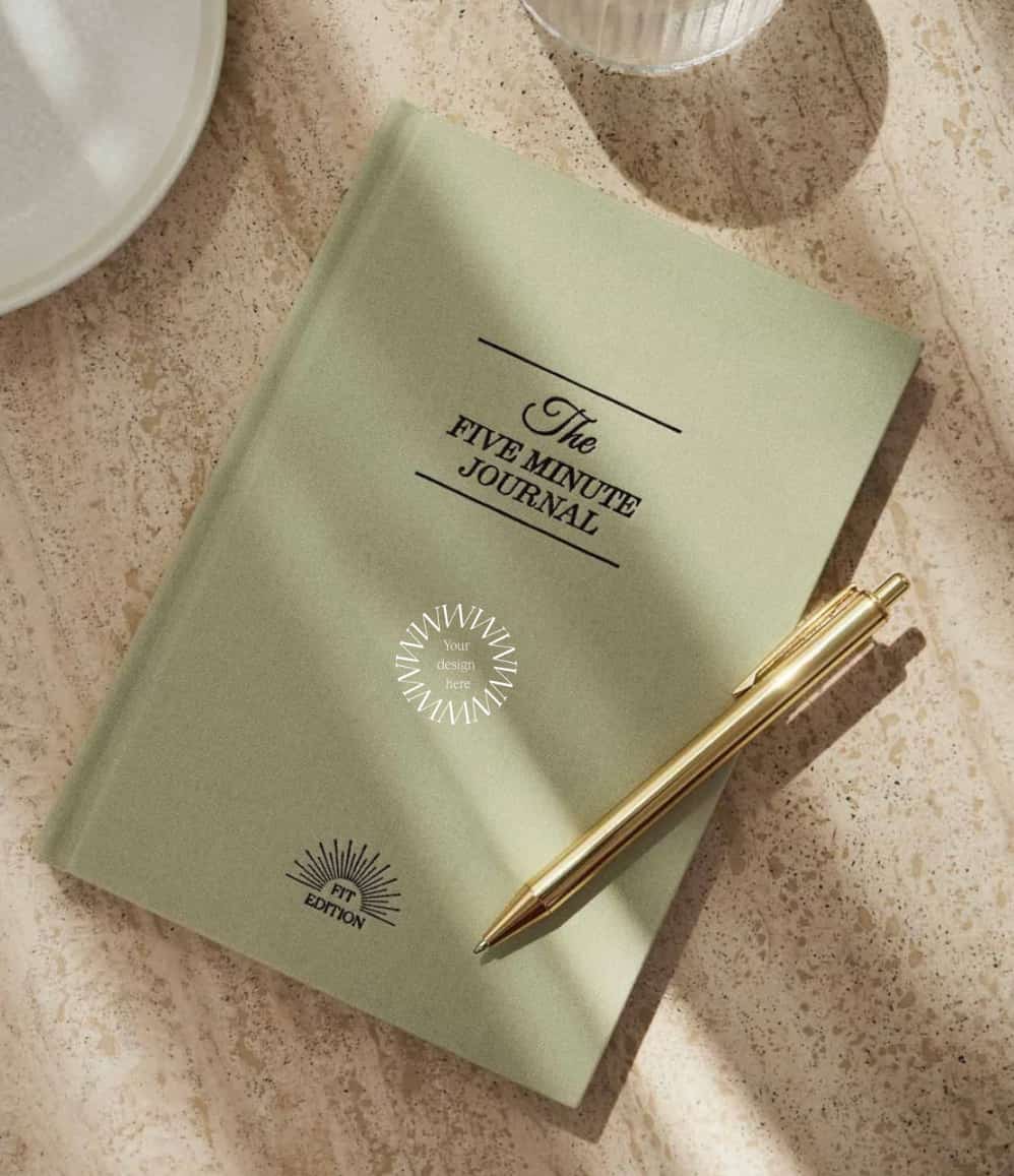 Five Minute Journal Health & Fitness Edition, front cover, styled, showing logo placement