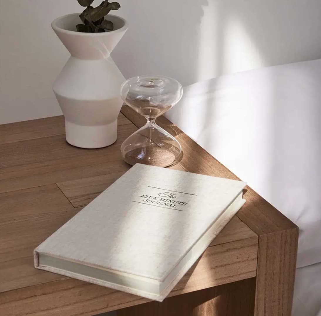 The Five Minute Journal, front cover in oat, styled