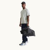Foldable Travel Bag with Wheels in Black lifestyle view, recycled PET sustainable premium merch, water resistant