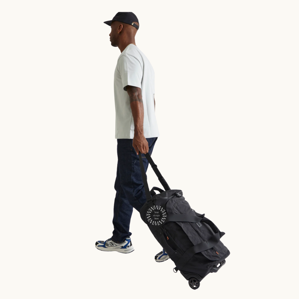 Foldable travel bag with wheels in black shown in rolling trolley mode, recycled rPET eco friendly corporate thank you gift