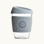 Glass Coffee Cup 12oz in grey, with a silicone thermal sleeve, showing logo placement