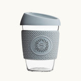 Glass Coffee Cup 12oz in grey, with a silicone thermal sleeve, showing logo placement