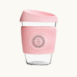 Glass Coffee Cup 12oz in pink, with a silicone thermal sleeve, showing logo placement