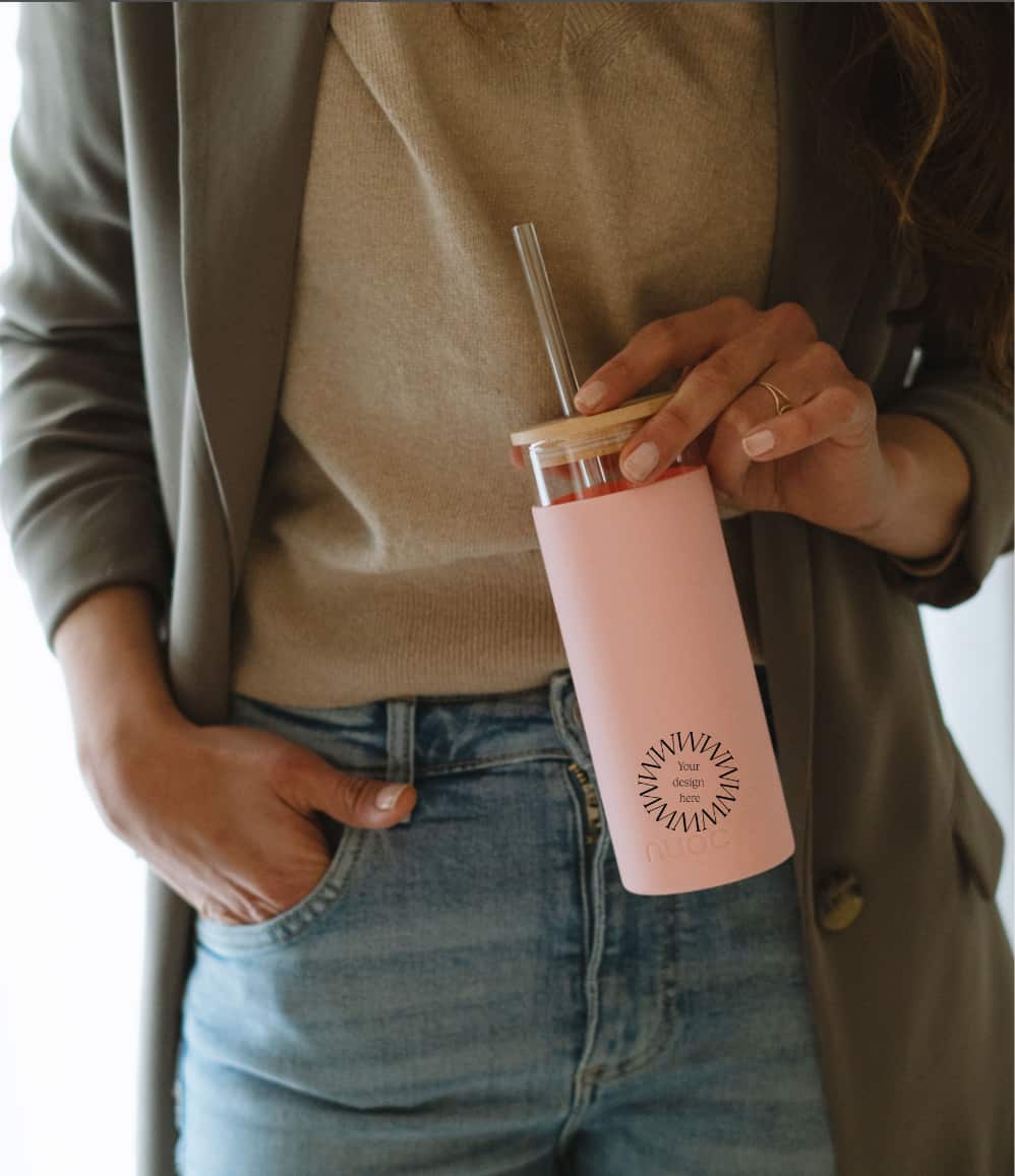 Glass Tumbler with Straw 450ml in pink, held by a woman, showing logo placement