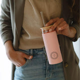 Glass Tumbler with Straw 450ml in pink, held by a woman, showing logo placement