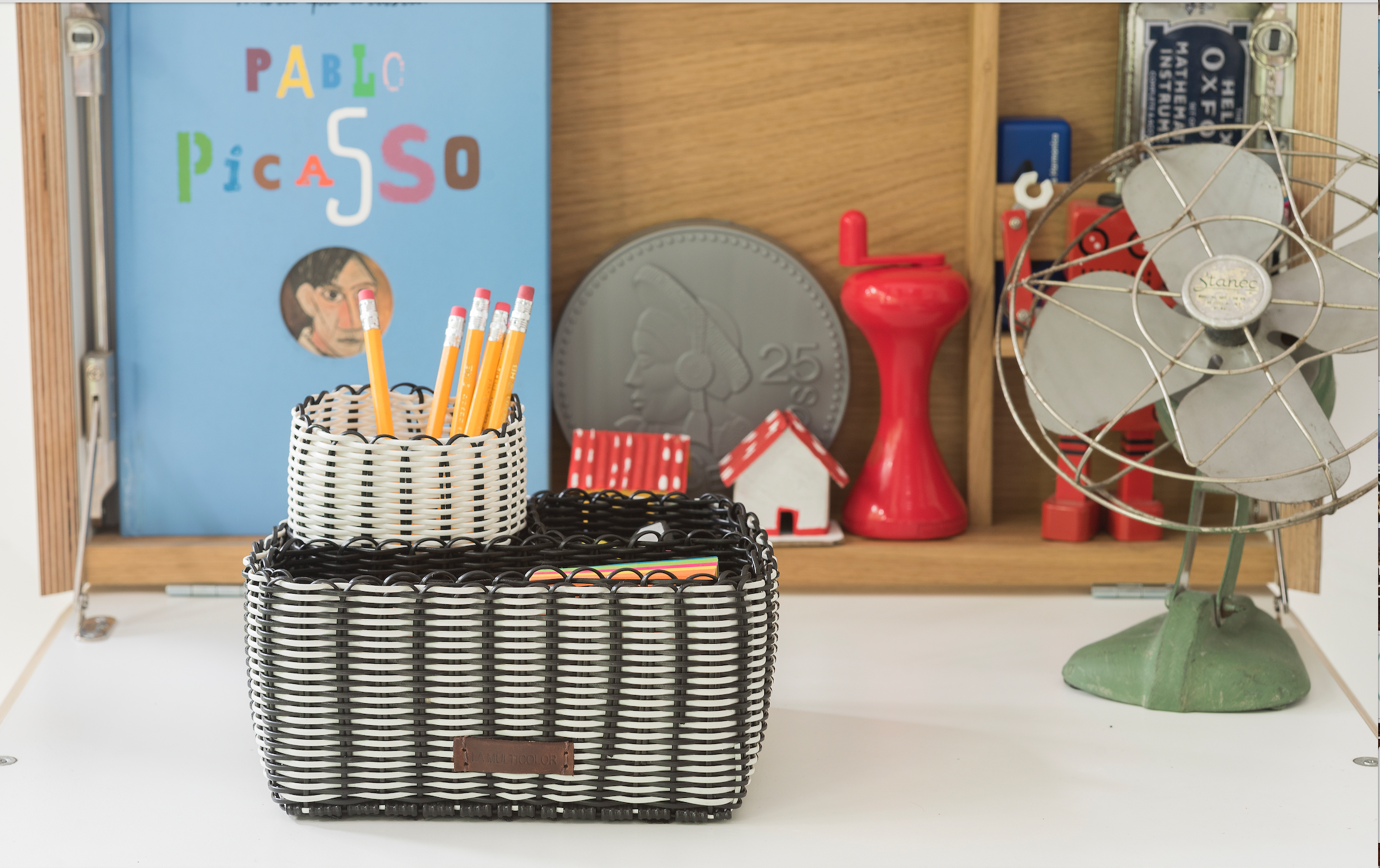 A handwoven upcycled desk organizer in black and white. Unique sustainable corporate gifts 