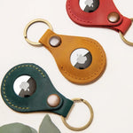 Leather AirTag holder available in mustard, forest green and red