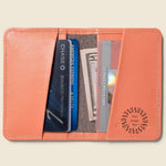Leather Bifold RFID Wallet in coral, open, showing logo placement.