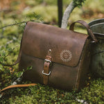 Hand-stitched leather crossbody bag in brown, a sustainable corporate gift from women-owned brands