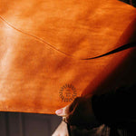 Orange leather laptop case in use, executive corporate gift for client gifting and senior leadership