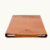 Hand-Stitched Leather Laptop Sleeve in cognac showing harness post closure and unlined interior, luxury corporate gift
