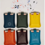 Leather travel playing cards set in yellow, orange, green, blue and burgundy, a sustainable corporate gift for client gifting and employee appreciation.