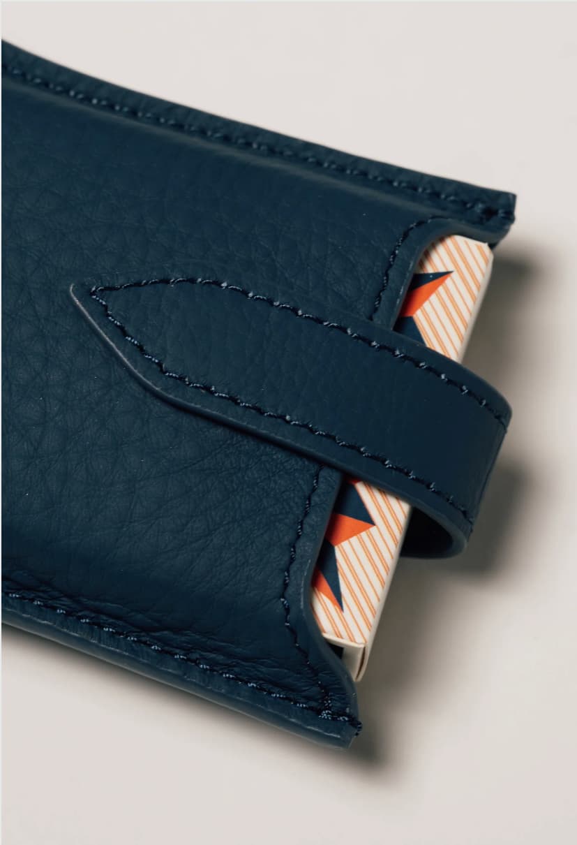 Blue leather travel playing cards set with magnetic closure, a personalised corporate gift from women-owned brands.