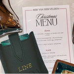 Leather travel playing cards set in use, showing cards, dice and notebook, a sustainable corporate gift for client and employees appreciating gifting