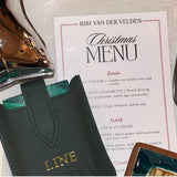 Leather travel playing cards set in use, showing cards, dice and notebook, a sustainable corporate gift for client and employees appreciating gifting