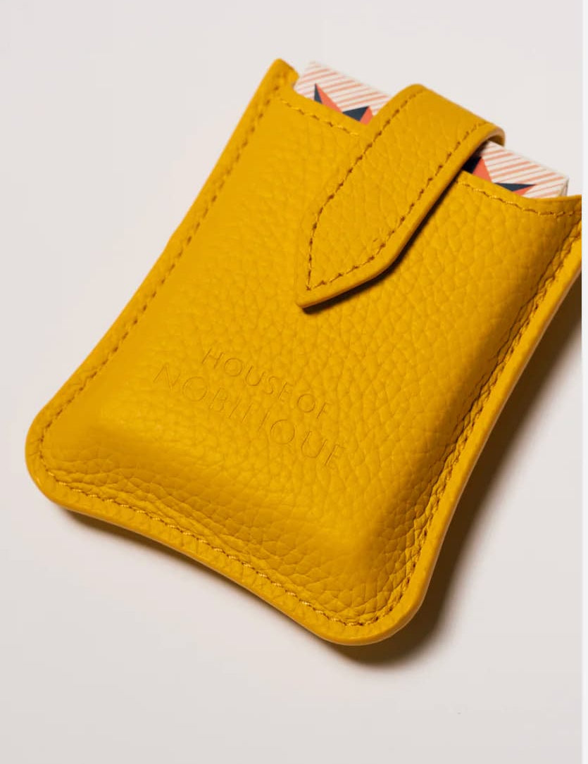 Yellow leather travel playing cards set, a sustainable corporate gift with cards, dice and notebook for VIP client gifting and brand activations.