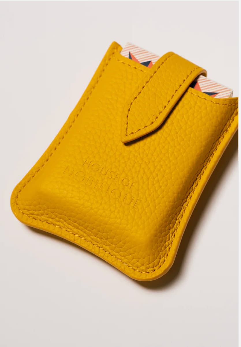 Yellow leather travel playing cards set, a sustainable corporate gift with cards, dice and notebook for VIP client gifting and brand activations.