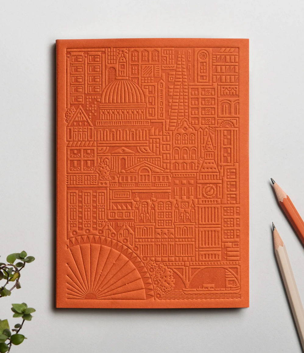 Debossed city of London notebook in orange. Premium eco swag for executive events. Personalised corporate gifts for women 