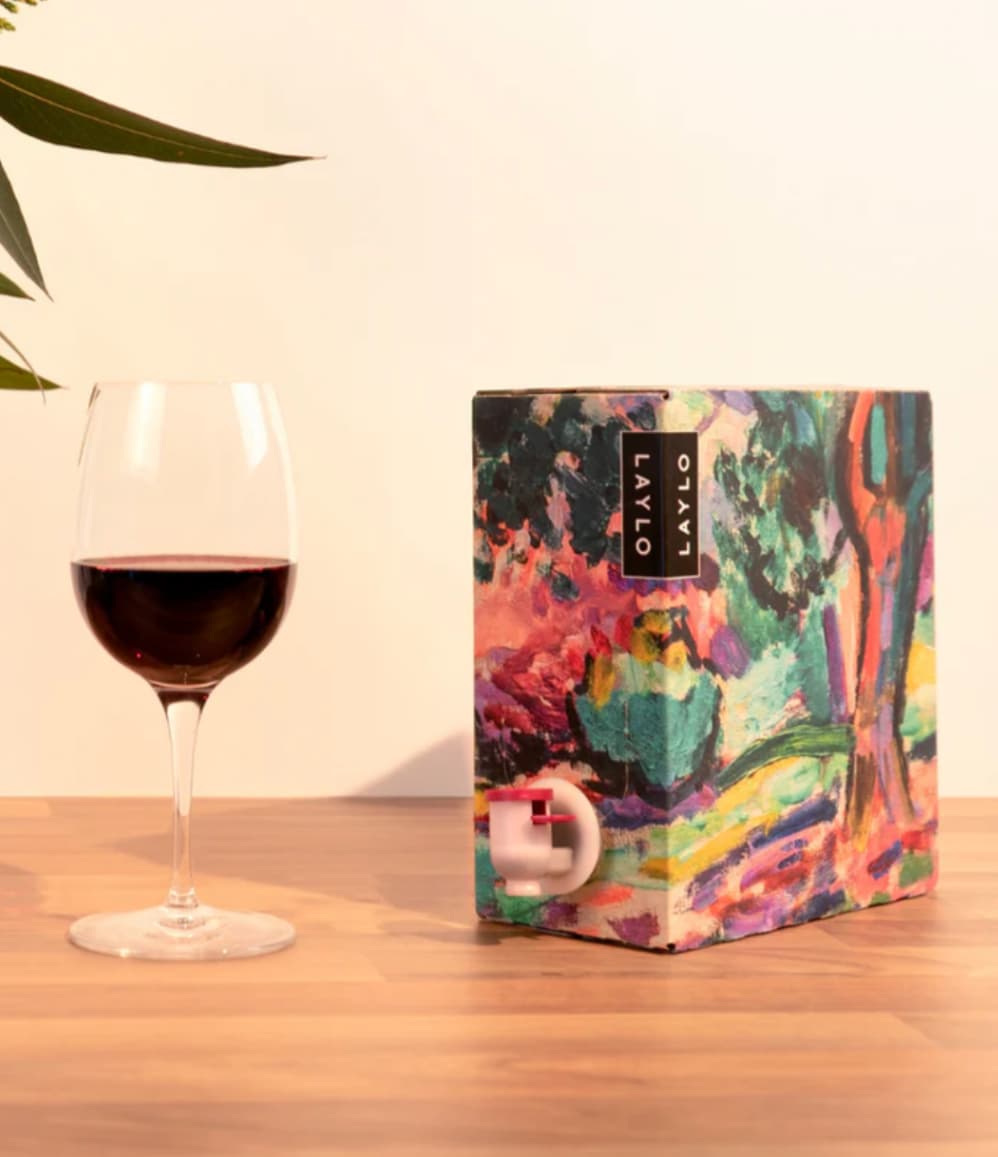 Merlot 2024, showing the Matisse-inspired box design alongside a glass of wine