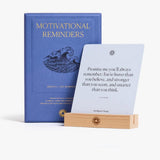 Motivational Reminders box beside a card displayed on the wood stand