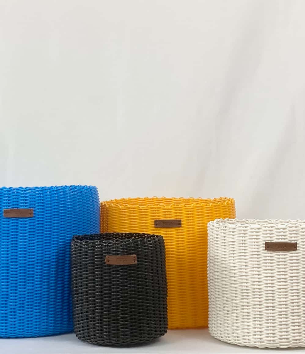 Handwoven upcycled office bins shown in a workspace setting
