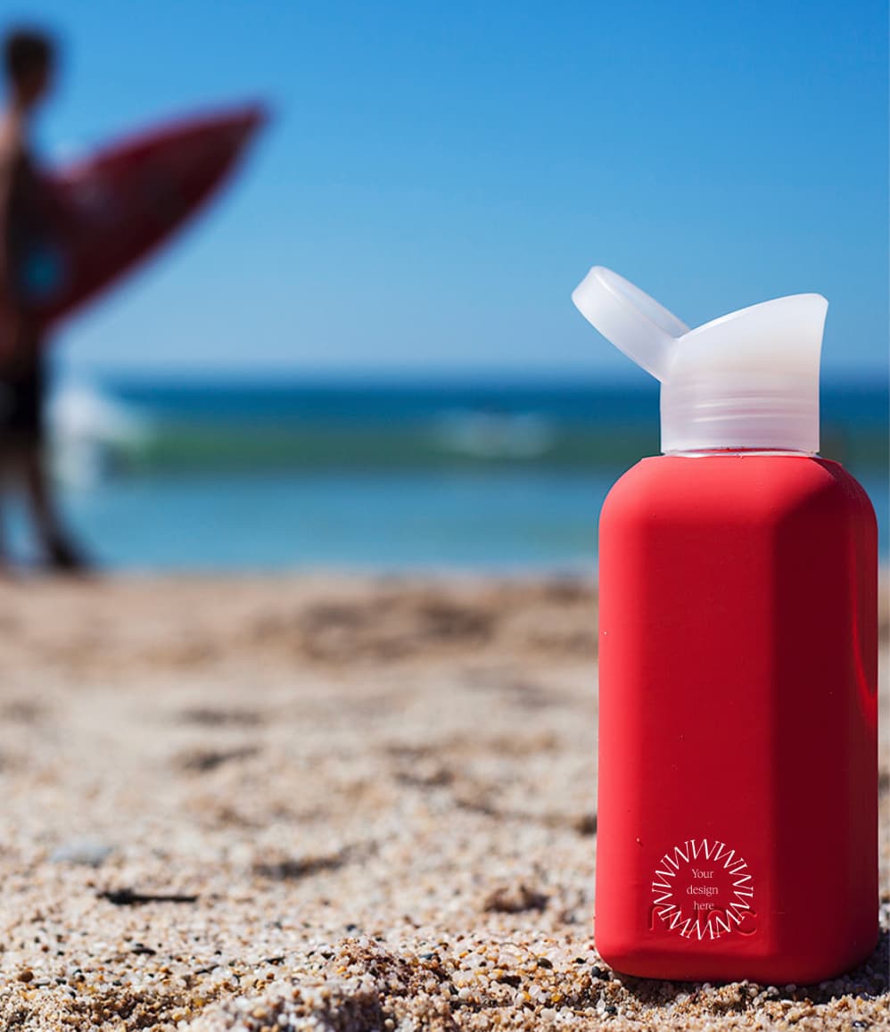 Reusable Glass Bottle 500ml in red, showing logo placement