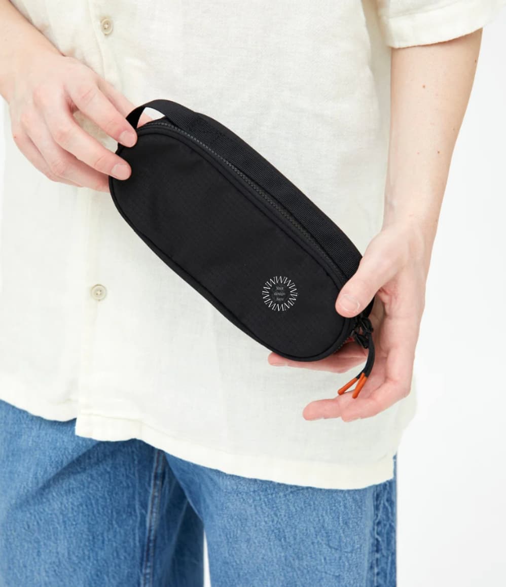 Oval Eco Pencil Case in black, held, showing logo placement