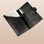 Black leather passport holder with card slot and document sleeve, an employee appreciation gift