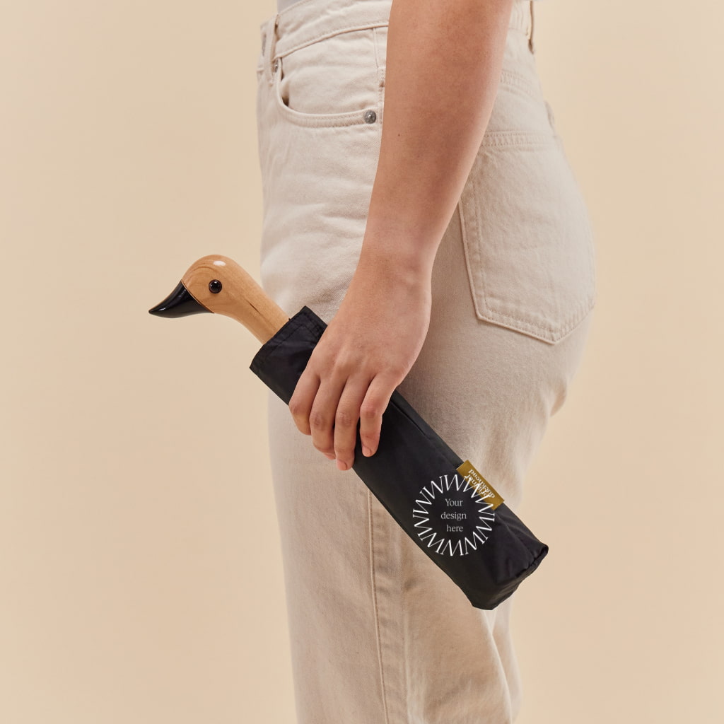 Personalised Black Duck Umbrella, being carried
