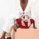Red handwoven summer straw bag from Ghana for corporate gifting, ideal for conferences and client events