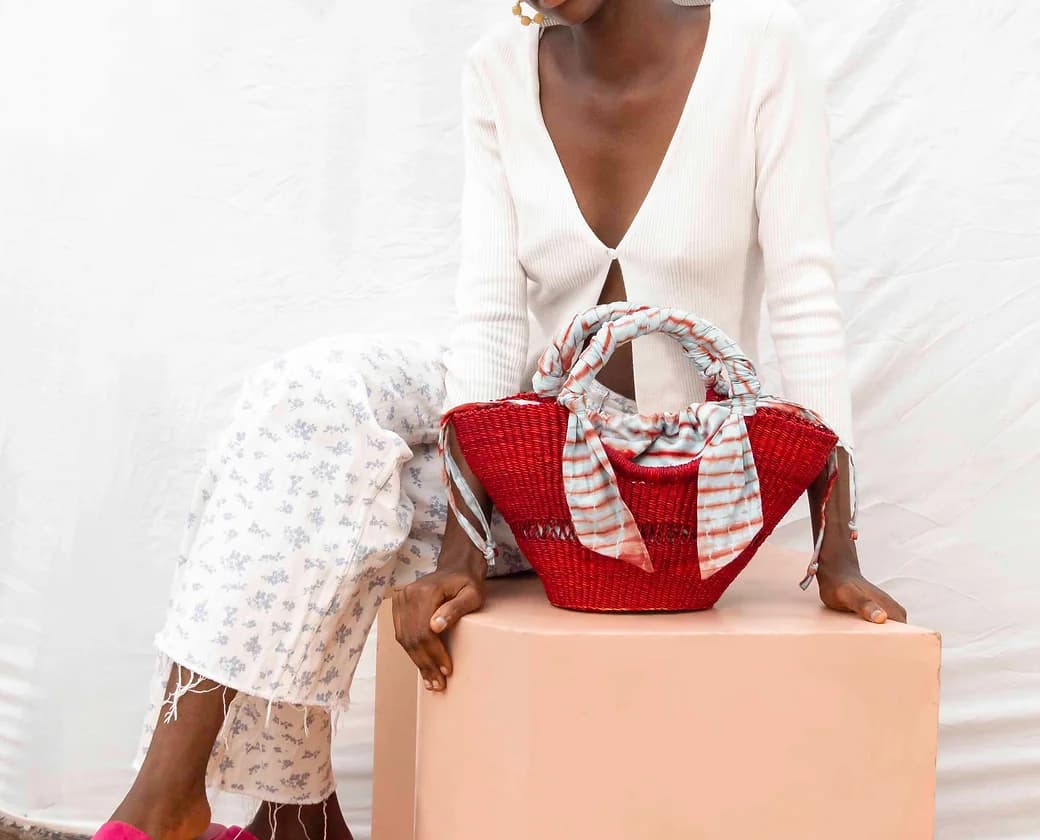 Red handwoven summer straw bag from Ghana for corporate gifting, ideal for conferences and client events