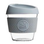 Grey reusable glass coffee cup with thermal sleeve, co-branded for premium merch.