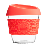 Orange reusable glass coffee cup with thermal sleeve, co-branded for premium merch