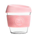 Pink reusable glass coffee cup with thermal sleeve, co-branded for premium merch.