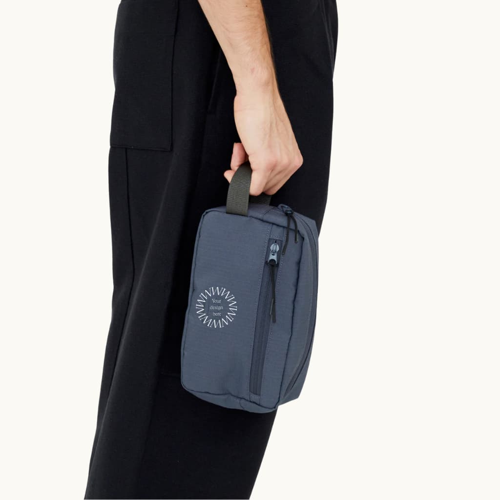 rPET Washbag in blue, being carried showing logo placement